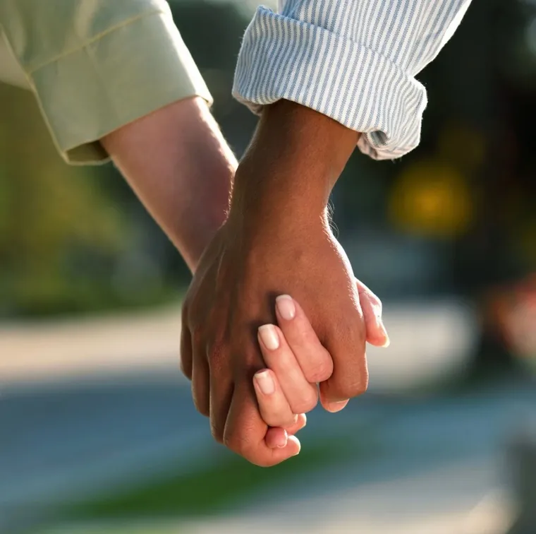 Two people holding hands
